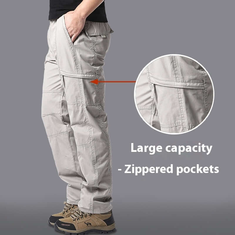 Men's light gray climbing trousers featuring large capacity zippered pockets for outdoor activities.
