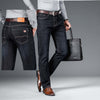 Men's loose straight jeans in dark blue denim, featuring a sleek design for casual wear and a smart belt.