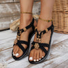 Ethnic style black beaded open toe sandals with floral decoration and elastic band for women, perfect for beach wear.