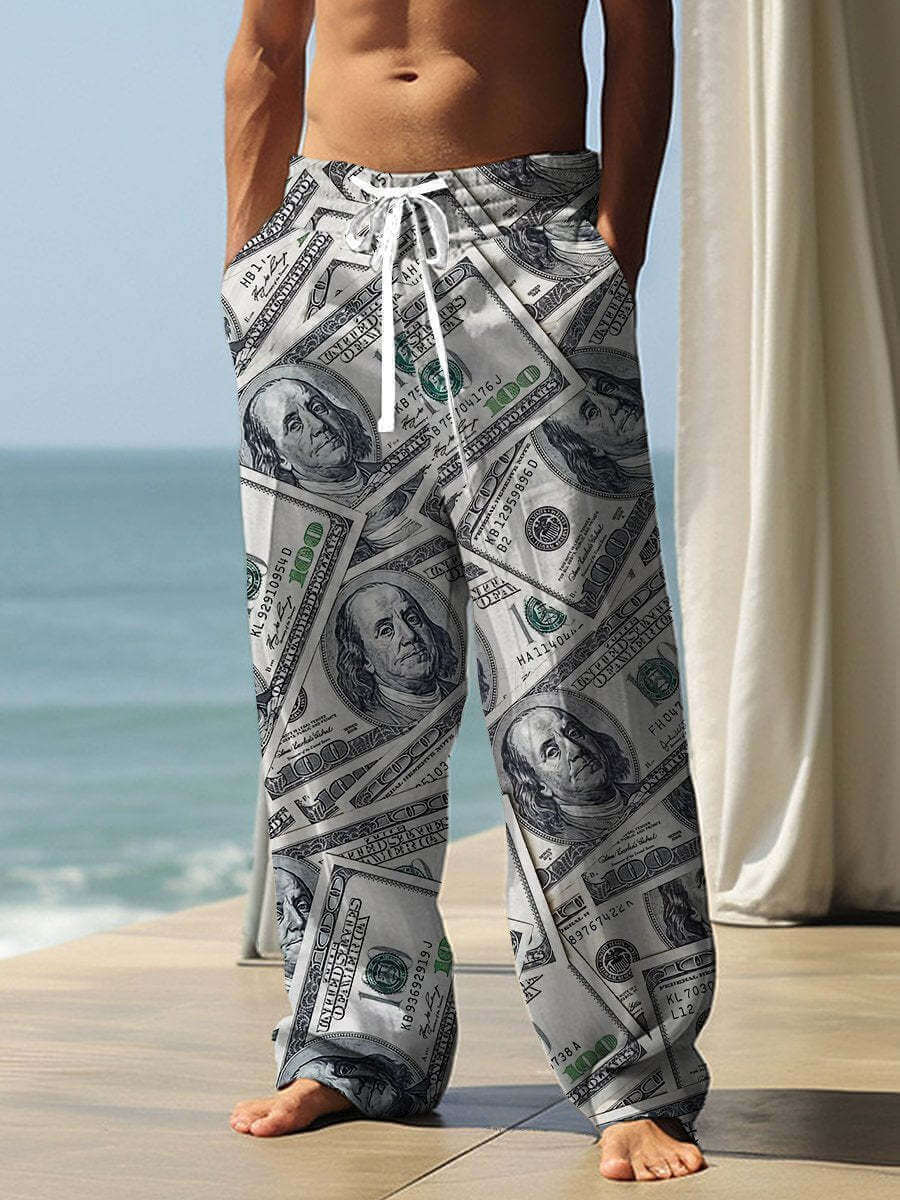 Men's baggy pants with money print, long straight-leg style, ideal for casual wear near the beach.