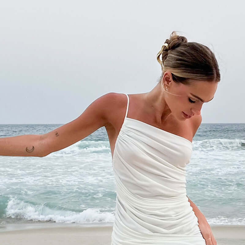 <p>Cut with fluid elegance, this silhouette glides through the evening with quiet confidence and an unmistakable sense of allure. Every movement reveals a refined presence that lingers long after the moment has passed.</p>